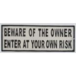 A 21st C Painted cast metal sign ' Beware of the owner enter at your own risk 5 x 14" long