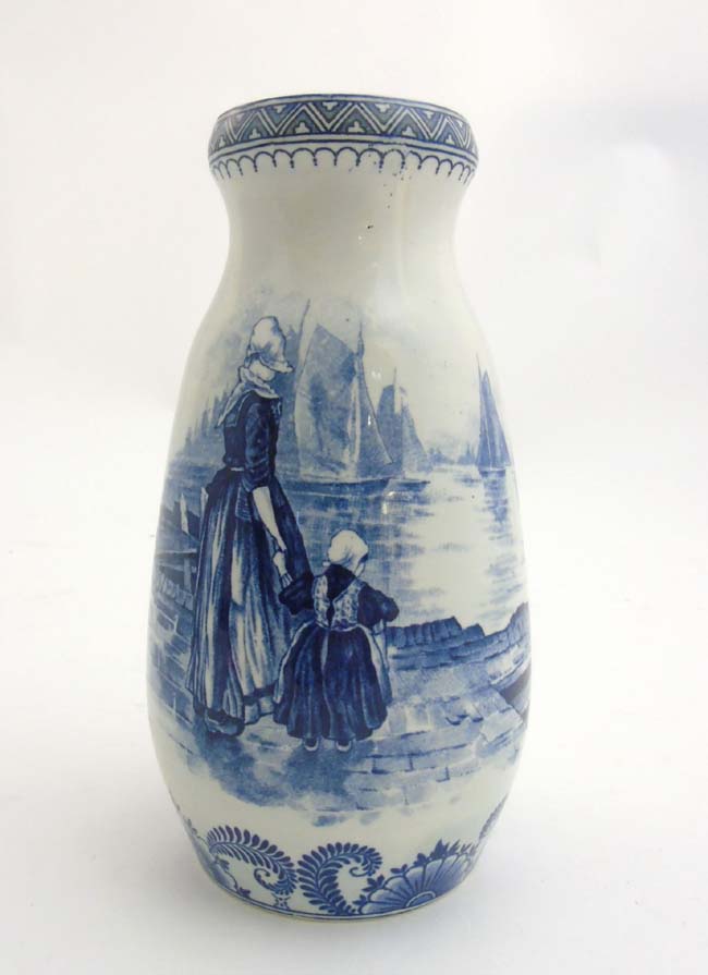 A circa 19th C Royal Bonn ''Delft'' blue and white vase depicting a Dutch mother and daughter