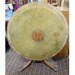 A 20th C tilt top circular breakfast table standing on a pedestal base with 4 lions paw feet,