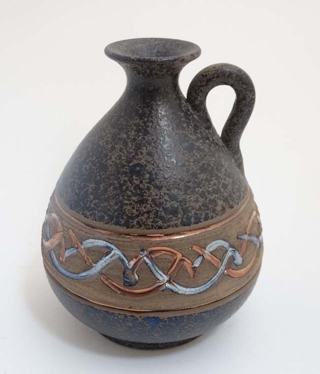 A Spanish Mejias Polonio Pottery pitcher,