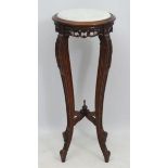 A mid - late 20thC Chinese hardwood marble topped circular four legged jardiniere stand 36" high