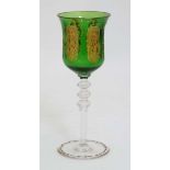 An early - mid 20thC facet cut green glass wine glasses with gilded rim,