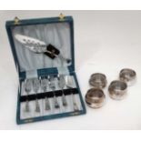 A set of 6 S/P pastry forks with server cased and 4 matching barrel shaped silver plated napkin