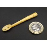 An unusual c1900 Continental carved miniature bone spoon with decorative handle. 2 5/8" long.