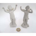 Two white bisque style porcelain Cherubs with wings and arms outstretched. The tallest 5'' high.