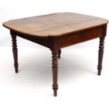 A mid 19thC oak centre / library table with frieze drawer to one side on ring turned legs.