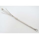 A silver and white metal swizzle stick 3 1/4" long (closed) CONDITION: Please Note