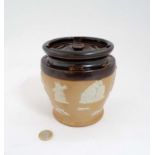 An early 20th C Royal Doulton salt glaze stoneware two- tone tobacco jar and lid decorated with