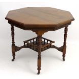A Victorian walnut octagonal two tier occasional table,
