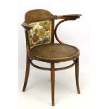 An early 20thC Bentwood circular seated open arm chair.