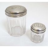 2 glass dressing table pots with French silver tops having engine turned decoration.