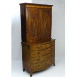A late 18thC mahogany bookcase standing on a mid 19thC mahogany chest of drawers,