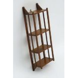 An Edwardian mahogany small set of shelves inspired by the Arts and Crafts movement.