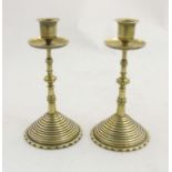 Decorative Metalware : A pair of Arts and Crafts 19thC cast brass secessionist candlesticks in the