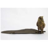 A 21stC novelty standish formed as an owl stooping upon a feather,