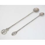 2 white metal long handled spoons with coin formed bowls and terminal to handles featuring the