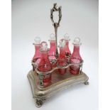 A silver plate cruet stand with Cranberry glass cruet bottle, approx.