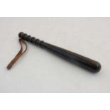 A 19th C lignum vitae Truncheon with turned decoration , leather strap 14 1/4" long.