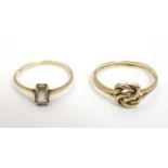 A 9ct gold ring with knot decoration together with a 9ct gold ring set with oval stone (2)