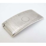 A silver visiting card case of shaped form with engine turned decoration.