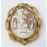 A late 19thC / early 20thC carved cameo brooch depicting a Classical Scene with figures and