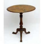 A late 19thC walnut tripod occasional table with marquetry inlay and boxwood stringing to the top ,