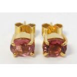 A pair of gilt metal stud earrings set with pink stones CONDITION: Please Note -