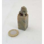A Chinese soapstone / jade waxed table seal surmounted by a Dog of Fo 2 1/6" high