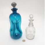 A turquoise glass decanter and stopper 11" high together with a small liqueur decanter and stopper