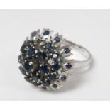 An 18ct white gold ring set with profusion of blue stones in a cluster setting