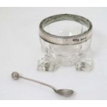 A glass salt with silver rim hallmarked Birmingham 1905 maker David Hollander & Sons.