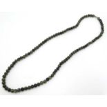 A green hard stone bead necklace approx 30" long CONDITION: Please Note - we do