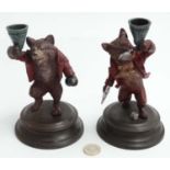 A pair of 21st C cold painted bronze novelty figurine/ candlestick holders on socles,