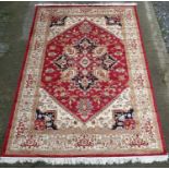 Carpet / Rug : A machine made woollen rug with red and buff central ground,