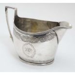 A Geo III silver cream jug with engraved decoration Hallmarked London 1800 maker Thomas Wallis II.