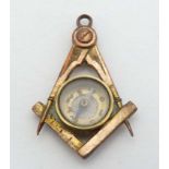 Masonic Interest : A gilt metal fob / pendant with masonic symbols having central compass.