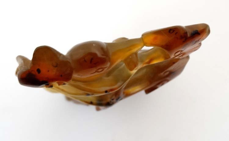 A carved russet jade ornament of a bird amongst foliage. - Image 4 of 5
