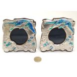 A pair of silver photograph frames with enamel floral scroll and bird decoration in the Art Nouveau