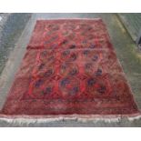 Carpet / rug : a signed antique hand made rug with eighteen octagonal designs to central ground,