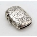 A Victorian silver vesta case with engraved decoration, hinged lid and striker under.