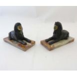 A pair of gilded bronze Egyptian sphinx on onyx bases.