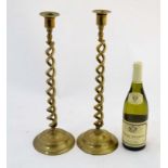 A pair of late 19thC double open twist candlesticks with circular bases,