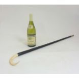 Walking Stick / Cane : A 19thC ebonised walking cane with horn end and boar tusk handle The whole