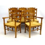 A set of late 20thC Continental oak ladder back chairs with rush envelope seats.