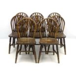 A set of 8 early - mid 20thC wheelback kitchen chairs with supported backs and standing 35" high