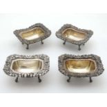 A set of 4 silver plate salts on four feel with acanthus and shell decoration to borders 4 1/4"