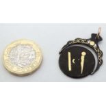 Masonic Interest: A damascene style metal fob/ pendant with central rotating section with white