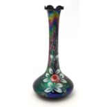 An Italian iridescent glass vase with rose decoration to side and retailers label to base.