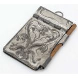 A silver plate Art Nouveau aide-memoire with scrolling floral and foliate honesty leaf decoration.