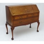 An early 20thC oak bureau with ebony inlay,